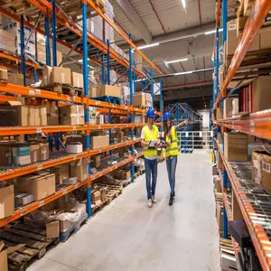 two warehouse workers walking distribution storage area discussing about logistics organization_342744 1456 2